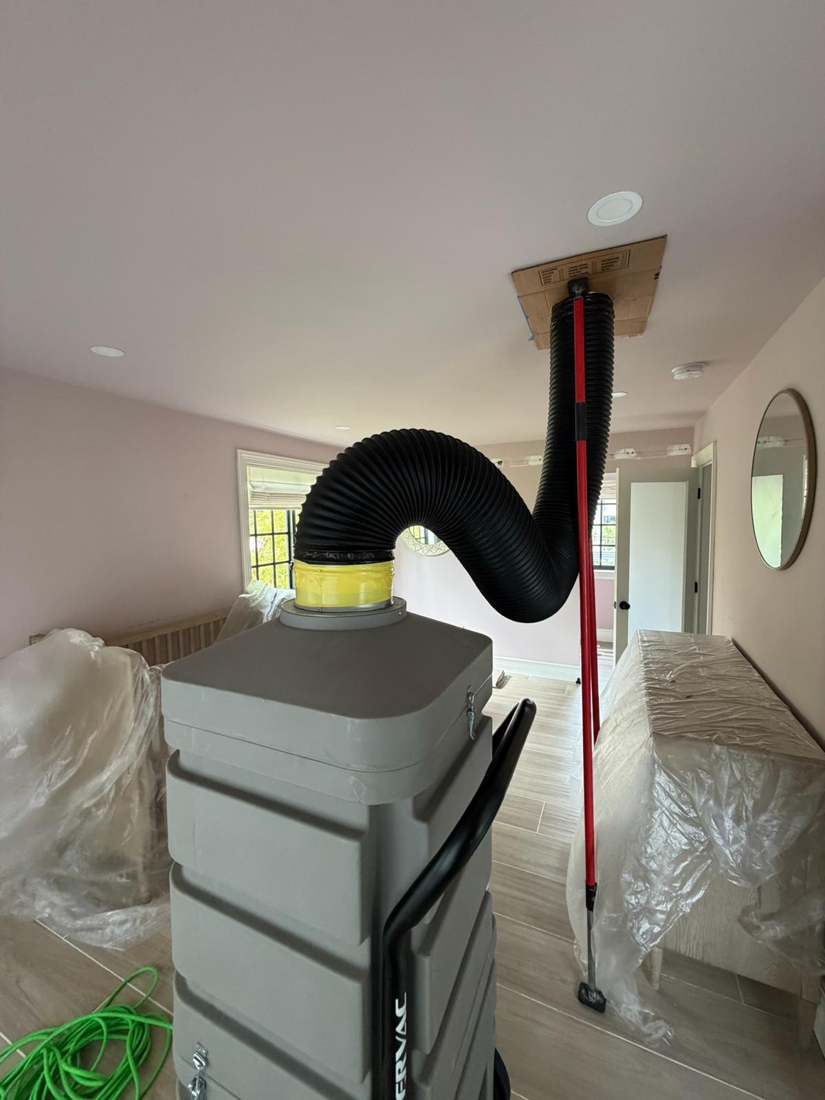 Professional HEPA-filtered duct cleaning equipment in a residential home