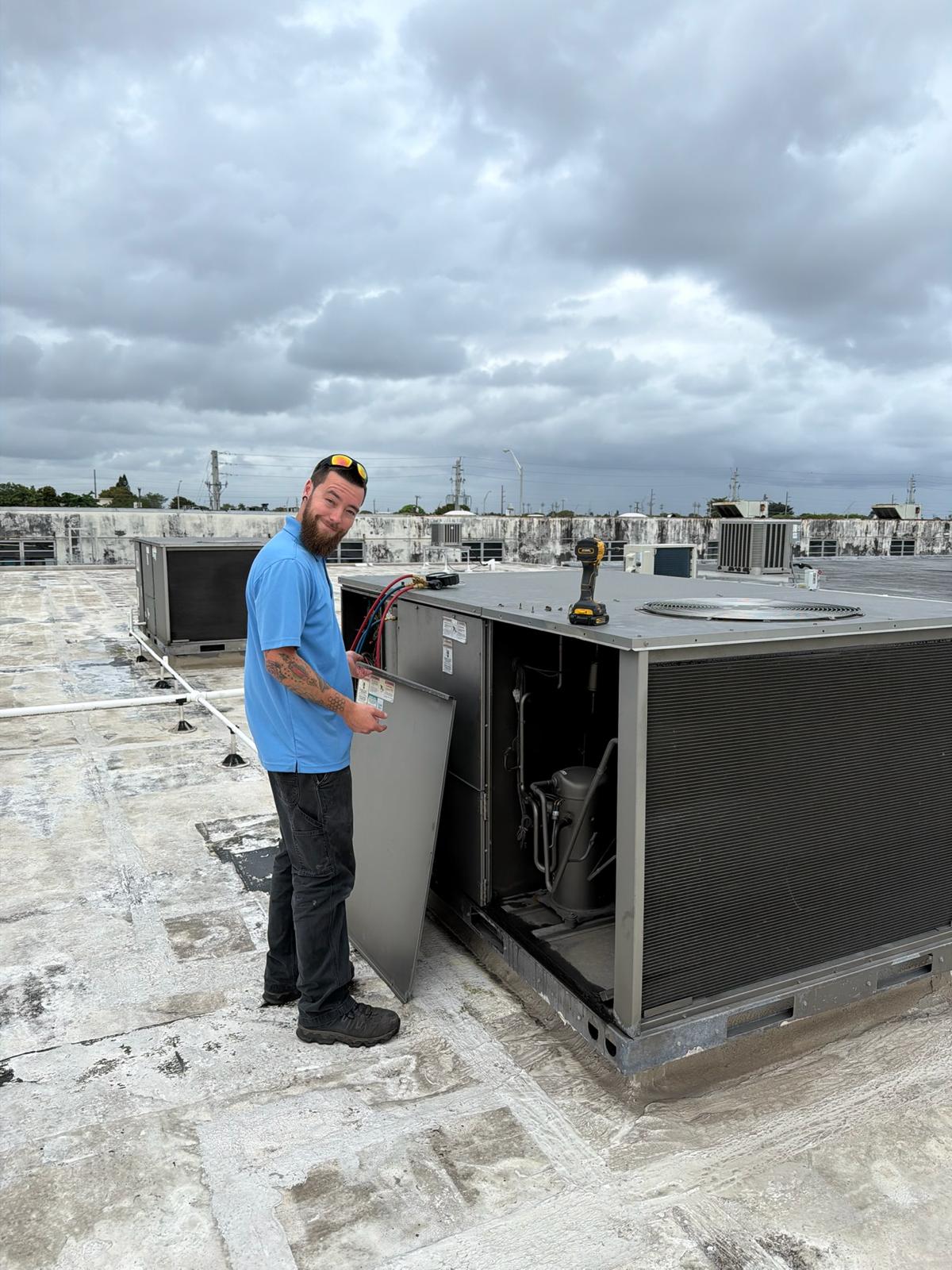 Air Force HVAC technician servicing a rooftop RTU unit