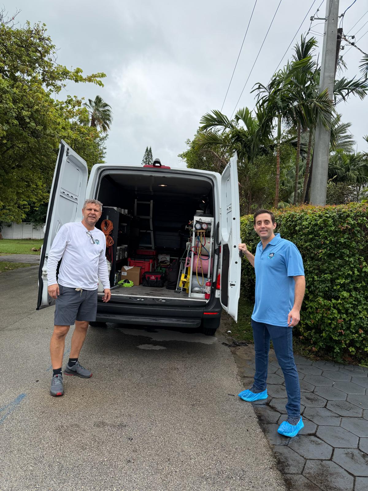 Air Force HVAC team with fully stocked service van ready for a job